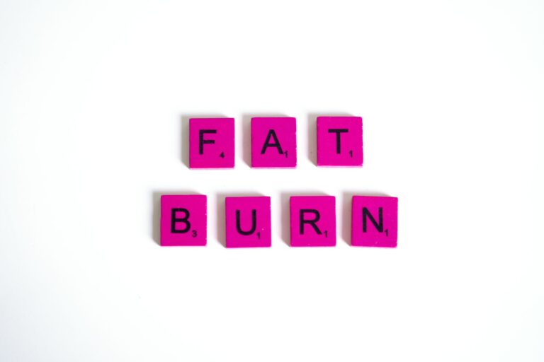 Pink scrabble tiles on a white background spelling 'Fat Burn'. Perfect for fitness and wellness concepts.